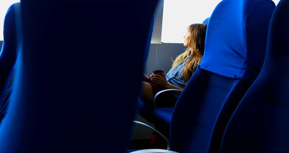 Woman Having Coffee While Travelling in Ferry alt