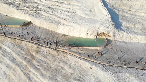 Visitors and Tourist People Walks Pamukkale's Calcium Carbonate Travertines alt