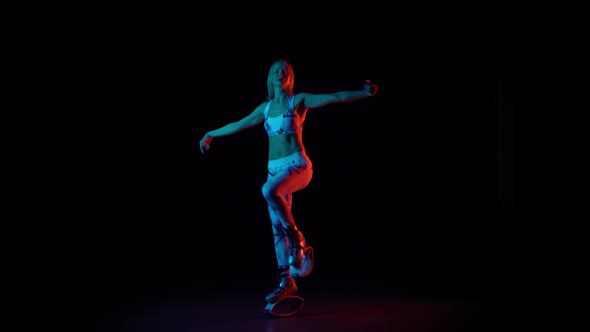 Girl in Sports Suit Is Dancing in Kangoo Jumps Shoes. alt