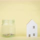 Stop motion animation mini house and coin into a clear glass jar on yellow background. - VideoHive Item for Sale