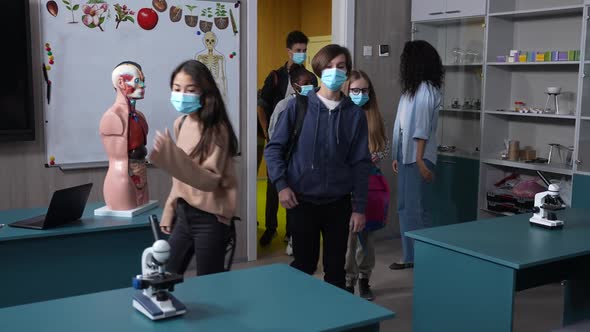 Masked Multinational Pupils Entering Classroom alt
