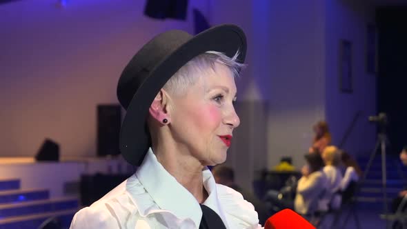 Elderly Woman Giving Interview to Journalist and Smiling Standing at Tv Studio During Show Spbd alt