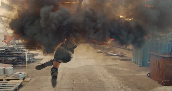 Young Aerial Gymnast Is Hanging in the Air with a Smoke Bomb in Hand Spinning alt