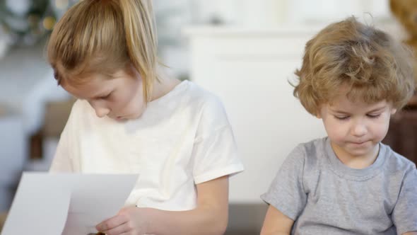 Cute Little Brother and Sister Making Paper Christmas Crafts alt