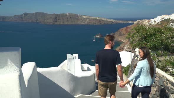 Rear View Couple Walking Down Stairs on Santorini Island