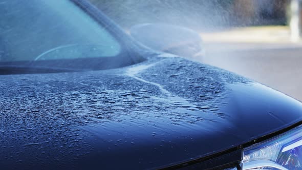 Washing car with high pressure water