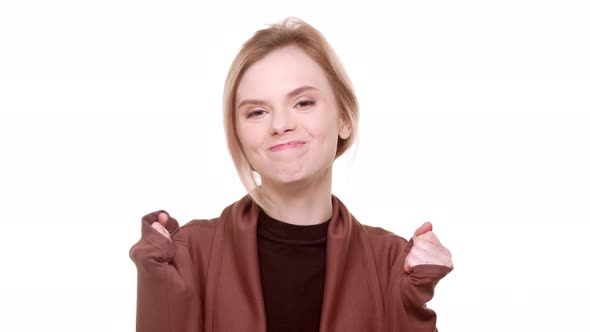 Attractive Teenage Girl Standing on White Background in Excitement and Smiling alt