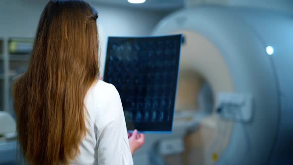 Medic examines x-ray in a contemporary clinic.  alt