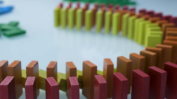 Line up of Dominoes in Rainbow Falling Colors with LGBT Colors of a Hand alt