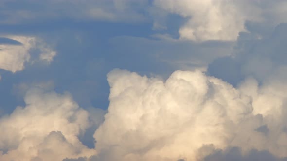 Fluffy cloud time lapse on a cloudy day 4k footage. alt