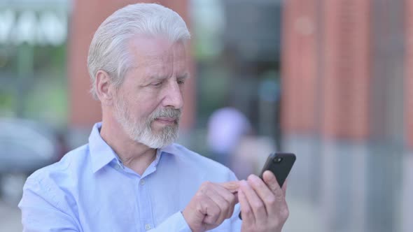 Outdoor Old Man Using Smartphone alt