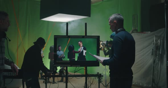 Cosmetician Preparing an Actor While Others Discussing the Scene alt