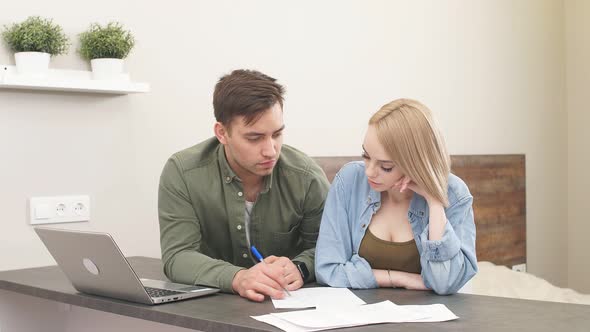 Beautiful Family Studies Bank Loan Documents on Laptop alt