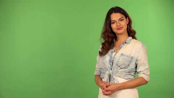 A Young Beautiful Caucasian Woman Nods at the Camera with a Smile  Green Screen Background