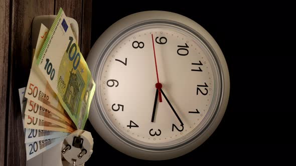 Closeup Shot of Euros and a Socket with a Clock Behind Them