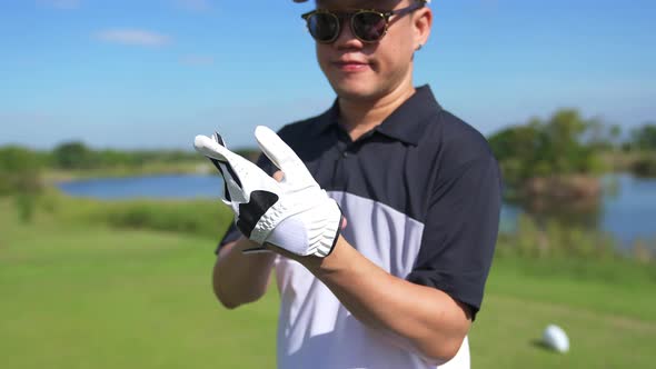4K Asian man golfer golfing at country club at summer sunny day. alt