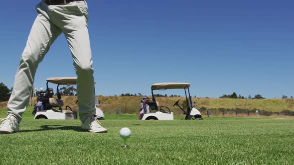 Caucasian senior man practicing golf at golf course on a bright sunny day alt