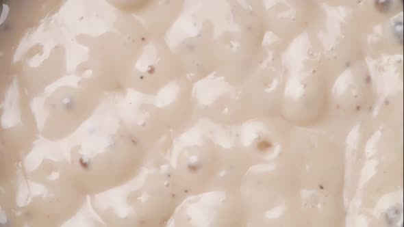 Homemade mushroom carbonara sauce in a pot on the electric stove in the kitchen. alt
