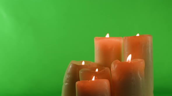 Burning Wax Candles on Green Chroma Key Background alt