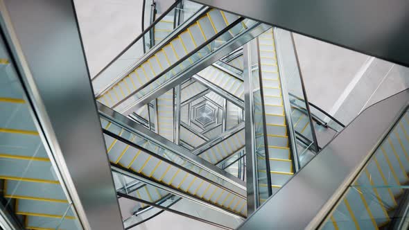 Puzzling labyrinth of escalators made of glass and steel. Complicated passages. alt