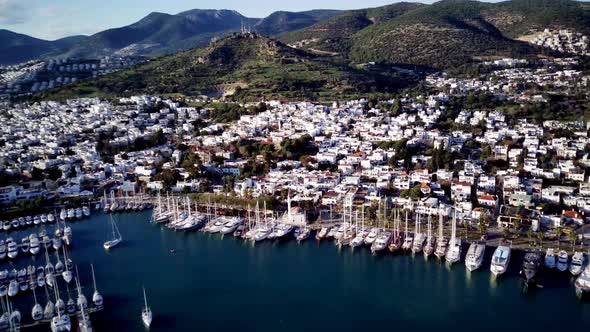 View from drone on full of yachts Bodrum harbour and ancient Kalesi castle in Mugla in Turkey alt