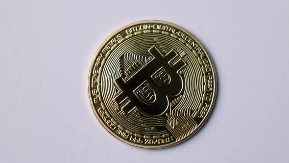 Bitcoin BTC coin rotate on 100 dollars USD bills. blockchain, mining GPU alt