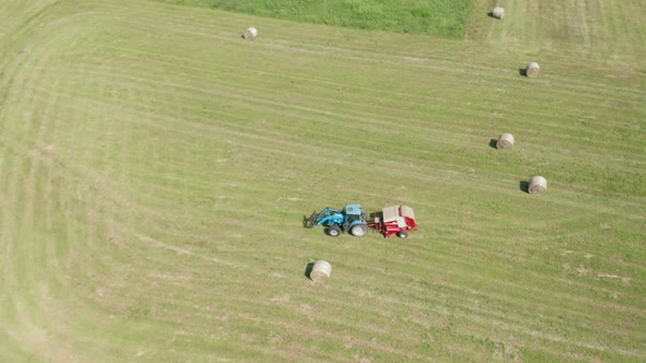 Blue Tractor Hay Bales Field Aerial View