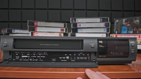 Insert VHS Cassette Into VCR and Push Play Button alt