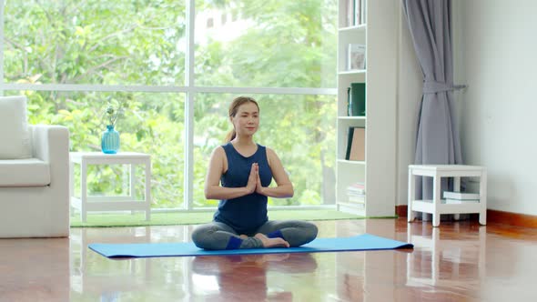 Young beautiful woman training yoga at home 