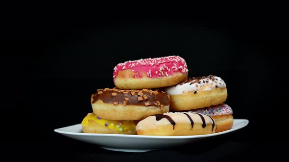 Donuts in Plate Being Picked Up