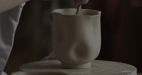 Brushing A Clay Cup In Pottery