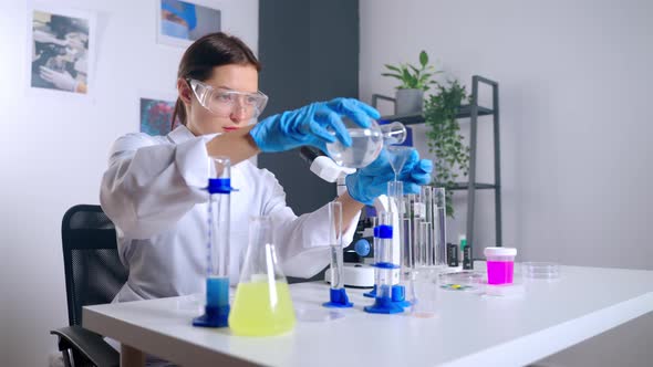 Woman Scientist is Experimenting in Chemical Laboratory