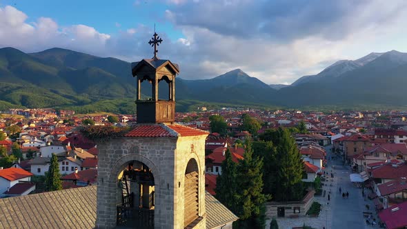 Panoramic View Of Bell Tower And Red Rooffs In Beautiful Rustic City In Mountain Region