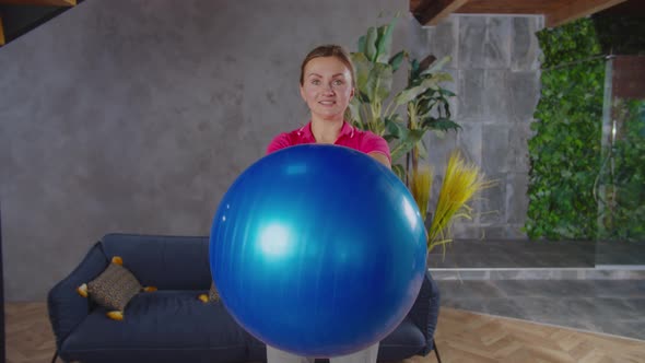 Sporty Female Doing Stability Ball Steering Wheel Exercise alt