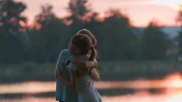 Happy Siblings Hugging Lovingly in Summer Park alt
