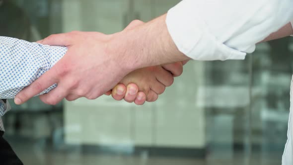 Close Up Two Men Shake Hands Conclude Successful Contract Agreement Sign of Support for Partnership alt