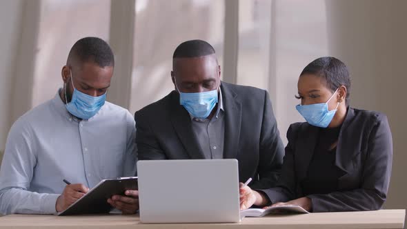 Diverse Afro Black Business Team in Protective Medical Face Masks Working in Modern Office alt