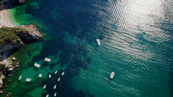 Aerial Drone View to Clear Blue Sea Water with Moored Boats and Yachts alt
