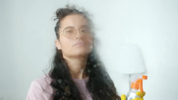Portrait of Female Cleaner Turning to Camera Spraying Water and Washing Indoors at Home alt