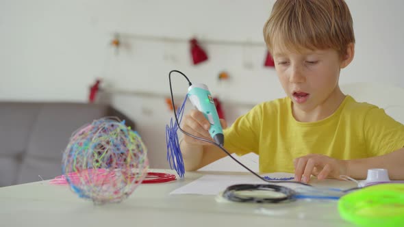 Close Up Shot of a Little Boy That is Using a 3d Pen alt