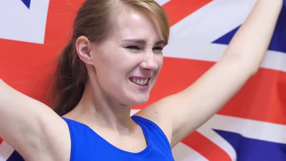 British Young Woman Celebrates Holding the British Flag alt