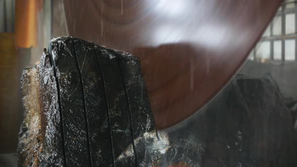 Large Industrial Stone Cutter Cuts Granite Rock Into Plates in Jets of Water Close Up alt