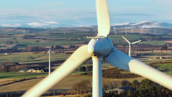 Wind Farm Turbines at Sunset Generating Renewable Power alt