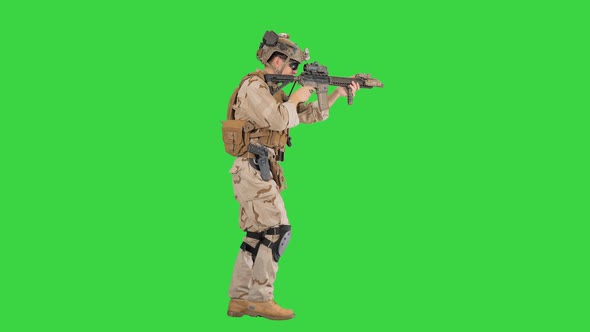 Soldier of Special Force Walking and Shooting on a Green Screen, Chroma Key. alt
