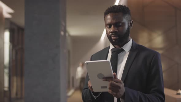 Black Man in Suit Using Tablet in Lobby of Hotel, Stock Footage | VideoHive