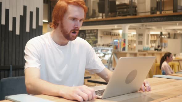 Astonished Amazed Redhead Beard Man Working in Cafe alt