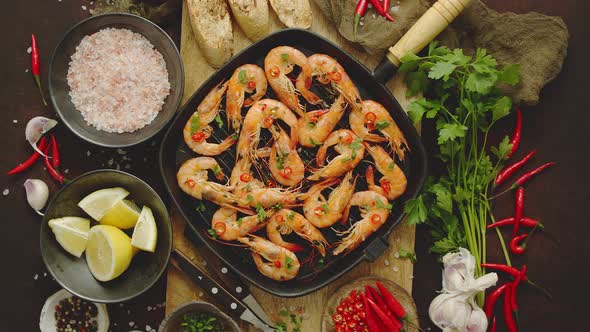 Tasty Appetizing Roasted Shrimps Prawns with Spices on Pan with Ingredients on Rusty Background alt