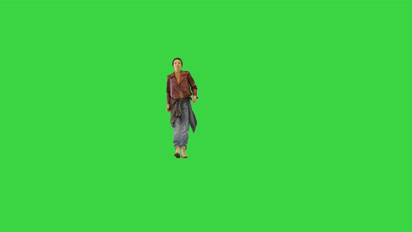 Young Girl in Stylish Urban Clothes Walks Dancing Slightly on a Green Screen Chroma Key