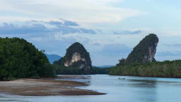 Time Lapse of Krabi Town River in the evening and Pak Nam cliffs on background