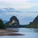 Time Lapse of Krabi Town River in the evening and Pak Nam cliffs on background - VideoHive Item for Sale